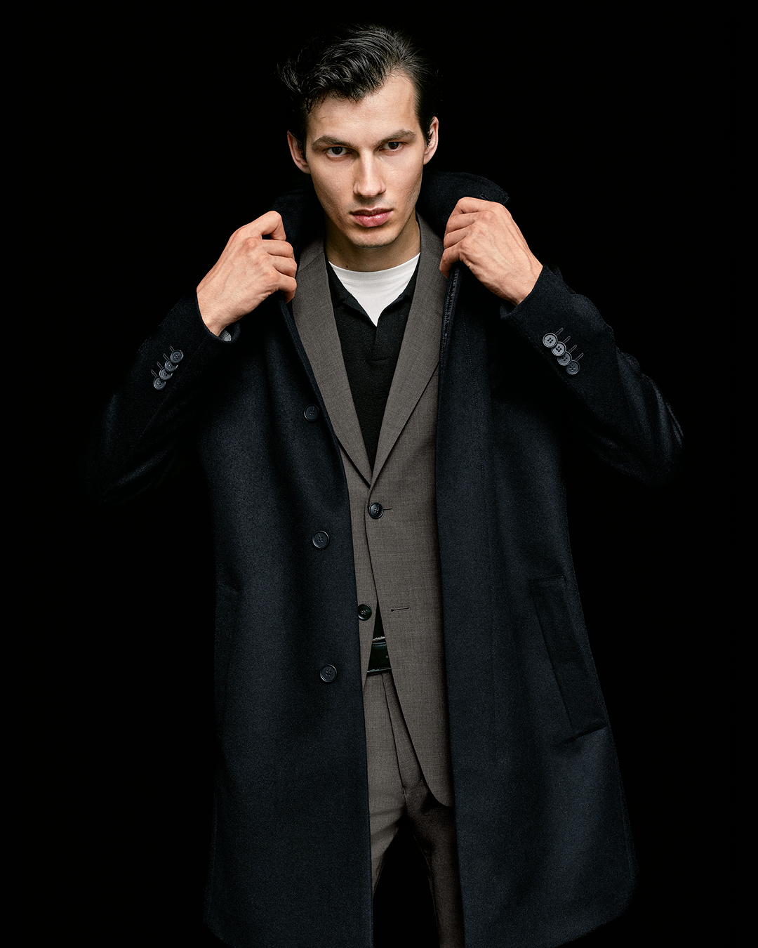 man in black coat with suit